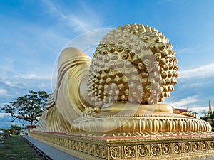 Huge Head golden sleeping Buddha with blue sky at Songkhla Thailand