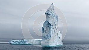 A huge high breakaway glacier drifts in the southern ocean off the coast of Antarctica at sunset, the Antarctic