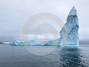 A huge high breakaway glacier drifts in the southern ocean off the coast of Antarctica at sunset, the Antarctic