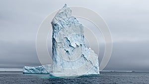 A huge high breakaway glacier drifts in the southern ocean off the coast of Antarctica at sunset, the Antarctic