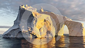 A huge high breakaway glacier drifts in the southern ocean off the coast of Antarctica at sunset, the Antarctic