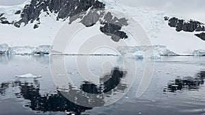 A huge high breakaway glacier is passing by in the southern ocean off the coast of Antarctica, the Antarctic Peninsula