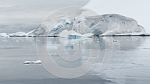 A huge high breakaway glacier is passing by in the southern ocean off the coast of Antarctica, the Antarctic Peninsula