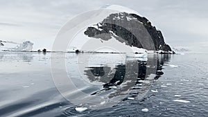 A huge high breakaway glacier is passing by in the southern ocean off the coast of Antarctica, the Antarctic Peninsula