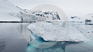 A huge high breakaway glacier is passing by in the southern ocean off the coast of Antarctica, the Antarctic Peninsula