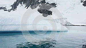 A huge high breakaway glacier is passing by in the southern ocean off the coast of Antarctica, the Antarctic Peninsula