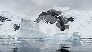 A huge high breakaway glacier is passing by in the southern ocean off the coast of Antarctica, the Antarctic Peninsula