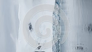 A huge high breakaway glacier is passing by in the southern ocean off the coast of Antarctica, the Antarctic Peninsula