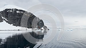 A huge high breakaway glacier is passing by in the southern ocean off the coast of Antarctica, the Antarctic Peninsula