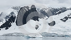 A huge high breakaway glacier is passing by in the southern ocean off the coast of Antarctica, the Antarctic Peninsula