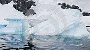 A huge high breakaway glacier is passing by in the southern ocean off the coast of Antarctica, the Antarctic Peninsula