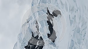 A huge high breakaway glacier is passing by in the southern ocean off the coast of Antarctica, the Antarctic Peninsula