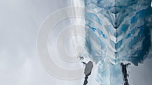 A huge high breakaway glacier is passing by in the southern ocean off the coast of Antarctica, the Antarctic Peninsula