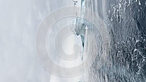 A huge high breakaway glacier is passing by in the southern ocean off the coast of Antarctica, the Antarctic Peninsula