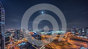 Huge highway crossroad junction between JLT district and Dubai Marina night timelapse.