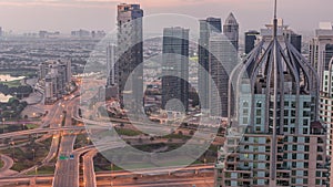 Huge highway crossroad junction between JLT district and Dubai Marina night to day timelapse.