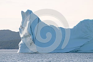 Huge iceberg with a stripe layer of sediment. Off the coast of Twillingate Newfoundland