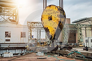 Huge industrial crane hook in the port for container cargo lifting.