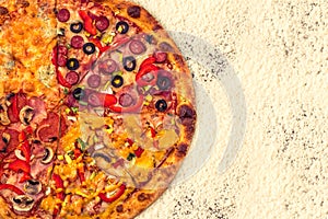 Huge international pizza on flour background