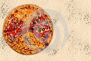 Huge international pizza on flour background