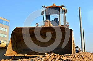 Huge iron bucket front loader at a construction site