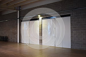 A huge iron white door in an empty hangar