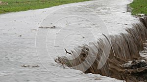 A huge landslide with a flowing dirty big puddle. Natural disaster