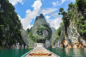 Huge limestone cliffs rising out of open lake at Khao Sok Nation