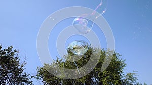 Huge long soap bubles flying in the sky. Two devices for creating a bubble.