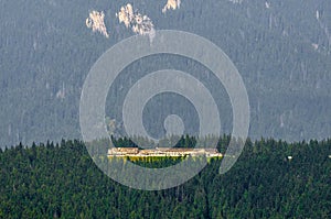 Huge mansion on a mountain top in the middle of the forest - mountain landscape