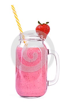 A huge mason jar of pink drink with a yellow straw and a small strawberry on top of it, isolated on a white background.