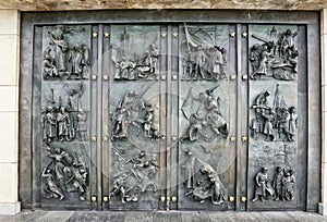 Huge metal door with plastic figures of Czech history