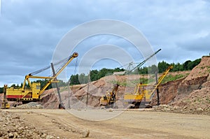 Huge mining excavator in the limestone open-pit. Biggests digger working in dolomite quarry. Largest tracked machine with electric