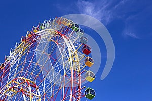 Huge modern colorful bright ferris wheel in an amusement