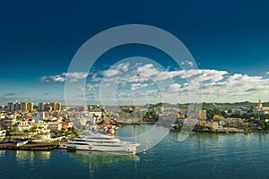 Huge motor boat in the port of Pointe-a-Pitre, with beautiful city on background Guadeloupe photo