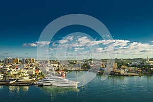 Huge motor boat in the port of Pointe-a-Pitre, with beautiful city on background Guadeloupe