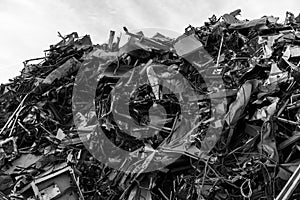 A huge mountain of metal pieces of different origin accumulated in a scrap yard
