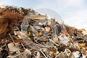 A huge mountain of metal pieces of different origin accumulated in a scrap yard