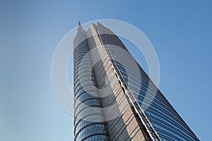 A huge multi-story modern office building against a blue sky. 01.2020 Milan
