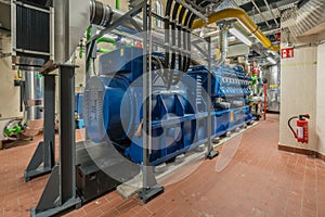 Huge natural gas engine works in a combined heat and power plant and supplies a district with heat