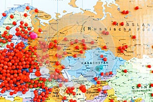 red pins in Europe and other continents on a world map with shallow DoF