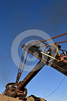 Huge old excavating shovel scoops a load of earth