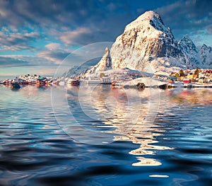 Huge peak reflected in the calm waters of Norwegian sea.