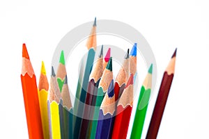 A huge pile of different colored wood pencil crayon placed on a white background