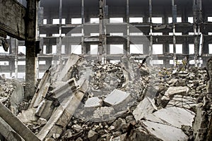 A huge pile of gray concrete debris from piles and stones of the destroyed building. The impact of the destruction photo