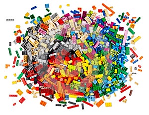 Huge pile of stackable plastic toy bricks top view isolated white background.  Colorful texture childhood education and