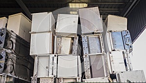 Huge piles of refrigerators stacked at recycling plant