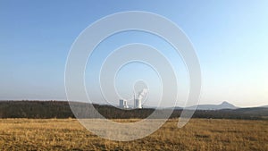 Huge pipes of a thermal power plant smoke slightly in the production process. Industrial landscape, atmospheric