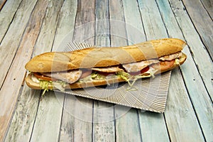 huge pork tenderloin sandwich with tomato, mayonnaise sauce