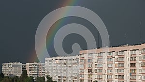 Huge Rainbow in the Cloudy Sky Above the Houses in City